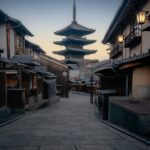 an empty street with a pagoda in the background